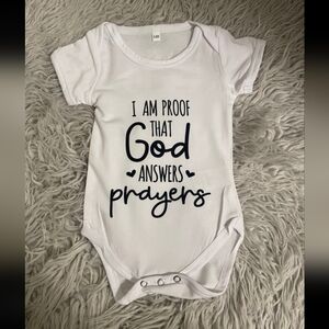 White Baby One-Piece Bodysuit with 'God Answers Prayers' Script